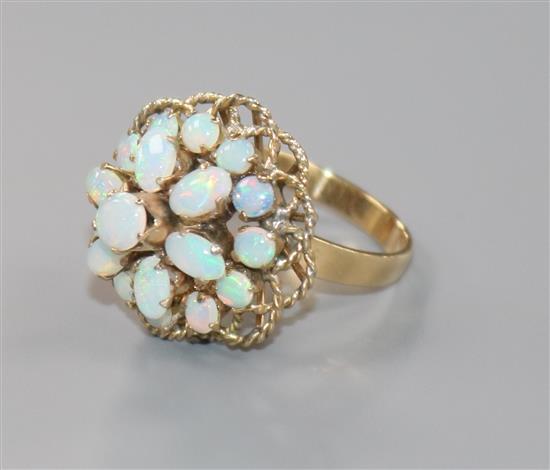 A modern 18ct gold and opal cluster dress ring, size M.